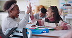 Classroom, school and teacher high five child for lesson, language skills and learning for assessment. Education, students and woman with girl with celebration for answer, knowledge and development