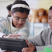 School kids, students and tablet in classroom for playing, learning and ...