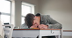 Desk, tired student and sleeping in classroom for burnout, dream and low energy for night studying. Teen boy, stress or fatigue for education with insomnia problem, rest and nap for school pressure