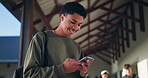 Boy, texting and smile on smartphone in high school, communication and gen z student laughing for online meme. Social media, typing and happy for education website results, connection and mobile app