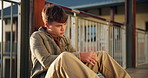 Boy, student and teen thinking on high school with social anxiety, stress and academic pressure or overwhelmed. Male learning, alone and sad on balcony with thoughts of exam, education and burnout.