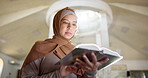 Muslim woman, reading and learning with quran at mosque for praying, worship or knowledge of Allah. Female person in hijab with religious or holy book for information or arabic literature at temple