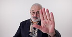 Stop, senior man and portrait in studio with hands up, opinion and instruction on white background. Elderly male person, hand gesture and command with mockup for warning, defense sign and objection