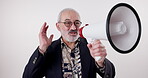 Megaphone, speech and senior man in studio for broadcast announcement, election news or info on white background. Microphone, noise and frustrated male speaker with message for change and vote