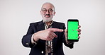 Senior man, face or phone for green screen mockup space in studio for app notification on white background. Online ads, offer or pensioner on mobile technology for marketing, announcement or promo