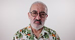 Serious face, senior man and glasses for clear vision, confident and model on grey studio background. Portrait, mature person and elderly guy with eyewear, frames and natural aging with floral shirt