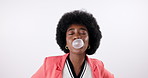 Black woman, blowing and pop with bubblegum in fashion for silly or goofy trick on white studio background. Portrait of young African, female person or model with afro, humor and playing with candy