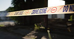 Crime, scene and ribbon with tape for warning, police crossing or investigation with closure, no entry or evidence. Empty or abandon house of murder mystery with sign for keep out, barricade or case