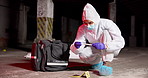 Swab, crime scene and person with evidence for forensic analysis, inspection and investigation. Hazmat suit, police tape and investigator with sample for criminal clues, accident and observation