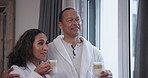 Happy couple, hotel and drinking coffee for vacation, holiday or getaway on valentines day or anniversary. Man and woman hug, love and talking together with warm beverage or chai latte for luxury