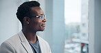 Black business man, thinking and window in office for vision, idea or reflection for job decision. Manager, entrepreneur and insight in workplace for choice, memory or view by glass for perspective