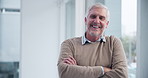 Laughing, arms folded and portrait of businessman by window with pride for career or company. Senior professional, ceo or management in workplace and happiness for investment or sales in New York