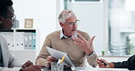 Mature, businessman and talking in meeting for documents, leadership or teamwork for briefing. CEO, investor or executive director speaking in discussion for feedback, planning or project portfolio