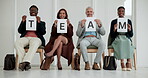 Sign, smile and team of business people in row, sitting on chairs with paper poster for solidarity. Collaboration, corporate and togetherness with happy employee group holding letter text for unity