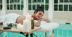 Spa, wellness, and woman on bed with massage for aromatherapy, happiness or luxury treatment. Candles, relax and person with eyes closed for stress relief, muscle reflexology or holistic detox