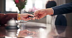 Hands, keys and reservation in hotel, table and hospitality for people in vacation and reception of business.  California, holiday and closeup of guest, booking and desk for accommodation in resort