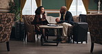 Business meeting, travel and people in hotel lobby for discussion, documents and agenda for company. Woman, businessman and international work in foyer for brainstorming, conference or negotiation