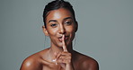 African woman, sequence and finger with hush, studio and silence for mystery announcement. Model, skincare secret and gossip with rumor, whisper and gesture for news with privacy on gray background