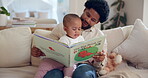 Black man, baby and reading with book in home, sofa and lounge for bedtime stories. Bonding, learning and educational study with single parent person, love and storytelling for childhood development