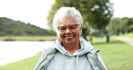 Smile, nature and face of senior woman with confidence for retirement vacation with outdoor exploring. Happy, pride and elderly female person from Colombia in outdoor park, garden or field with wind.