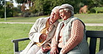 Elderly, women and happy with hug on park bench for Friendship, bonding and embrace with love for companion. Senior female people, outdoor and relax in environment with conversation and care together