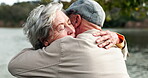 Care, support and elderly couple with hug by river for kindness, sympathy and comfort in news. Nature, water and people with gesture of love in retirement for gratitude, compassion and understanding