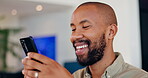 Black man, smile and phone for typing at house for reading news, communication notification and scroll on social media. Happy, male person and mobile for networking, online chat and entertainment
