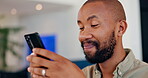 Black man, happy and phone for typing at house of reading news, communication notification and scroll on social media. Male person, smile and mobile for networking, online chat and entertainment

