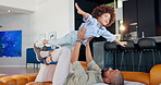 Happy father, sofa and playing with son in air for flying, freedom or weekend at home. Dad, child or little boy enjoying playful holiday or bonding together on lounge couch in living room at house