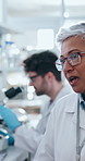 Chemical, science and woman in lab, glasses and people with feedback from mentor, gloves and medical research. Healthcare, intern and mature scientist with investigation, biotechnology and tablet