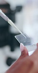 Hand, chemical and sample on glass, science and experiment for medicine, healthcare and cure for disease. Lab, scientist and closeup of person, medical research and study of liquid for vaccine