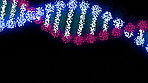 Spiral, neon and dots of dna on black background for genetic information storage and stem structure for genes. Double helix, science and strand for evolution, molecule transmission and chromosomes.