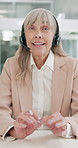 Senior woman, consultant and talking with headphones at call center for customer service or advice at office. Portrait or pov of mature female person or agent speaking with mic for online assistance