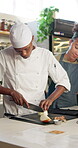 Kitchen, culinary students and chef with cut for teaching, skills development and knife technique. Cooking class, male cook and onion with team for learning, education and listening to professional