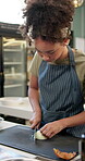 Culinary, woman and knife with onion for cut, chop and food preparation technique for fine dining on table. Kitchen, cooking and female chef with raw vegetable, hospitality or helping hand for skills