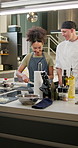 People, training and chef in kitchen for cooking class, learning and teaching at culinary school or academy. Food, cuisine and teacher, woman or student cutting onions for preparation in hospitality