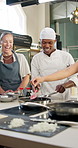 People, chef and cooking class in kitchen with student, industry or hospitality for diet, nutrition or food. Man, culinary and gourmet cuisine for menu, professional or skill in preparation at school