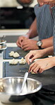 Hospitality, hands and pastry with chef for dumplings, shape and fold technique with food on table. Kitchen, people and professional cook with dough for preparation, culinary and dish as fine dining