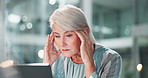 Headache, mature woman or stress in office for finance, company debt or overwhelmed in business. Female administrator, frustrated or anxiety at desk for budget crisis, tired or brain fog at computer