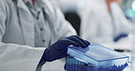 Hands, gloves and blood sample in lab with box for test, assessment or clinical analysis at pharma company. Scientist, person and plastic container with dna, results and ppe with vaccine development