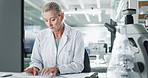 Mature woman, scientist and research on computer at lab for data capture, medical and science. Female person, results and healthcare on website for solution, drug trial and writing report or feedback