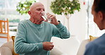 Old man, caregiver or drinking water in nursing home for health with prescription, antibiotics or wellness. Safety, retirement or elderly care with patient for arthritis pain, supplements or dementia