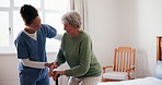 Caregiver, senior woman and help in bedroom at nursing home with cane for walking. People, nurse and pensioner in conversation at retirement house for support, care and healthcare with smile