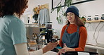 Woman, cashier and pos payment in cafe for coffee purchase, transaction or scanning mobile. Service, barista and customer at restaurant for bill, nfc machine or point of sale with smartphone