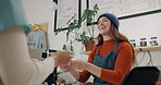 Women, waiter and customer in retail cafe with smile for coffee on break and relax. People, happy and satisfied at lifestyle store or shop for tea in small business as barista with client for service