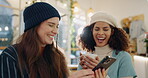 Women, friends and laughing with phone in coffee shop for online gossip, joke and post on media. Happy, people and relax with tech in restaurant for funny information, comedy and digital news story