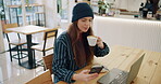 Drink, woman and relax with smartphone in coffee shop, freelance blogger and online entrepreneur as content creator. Girl, laptop and happy in cafe, creative director and internet for trend search.