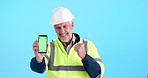 Face, green screen and man with smartphone, engineering or bonus on blue studio background. Maintenance, ux presentation or person with cellphone, tracking markers and celebration for construction