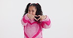 Girl, kid and heart hand in studio portrait with happy review, opinion and icon for positive attitude. Smile, face and child with sign for care, love emoji or kindness gesture on white background