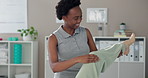 Black woman, physiotherapist and senior patient with legs stretching for rehabilitation, support and healthcare. People, arthritis and smile in clinic for fitness, exercise and workout for muscles